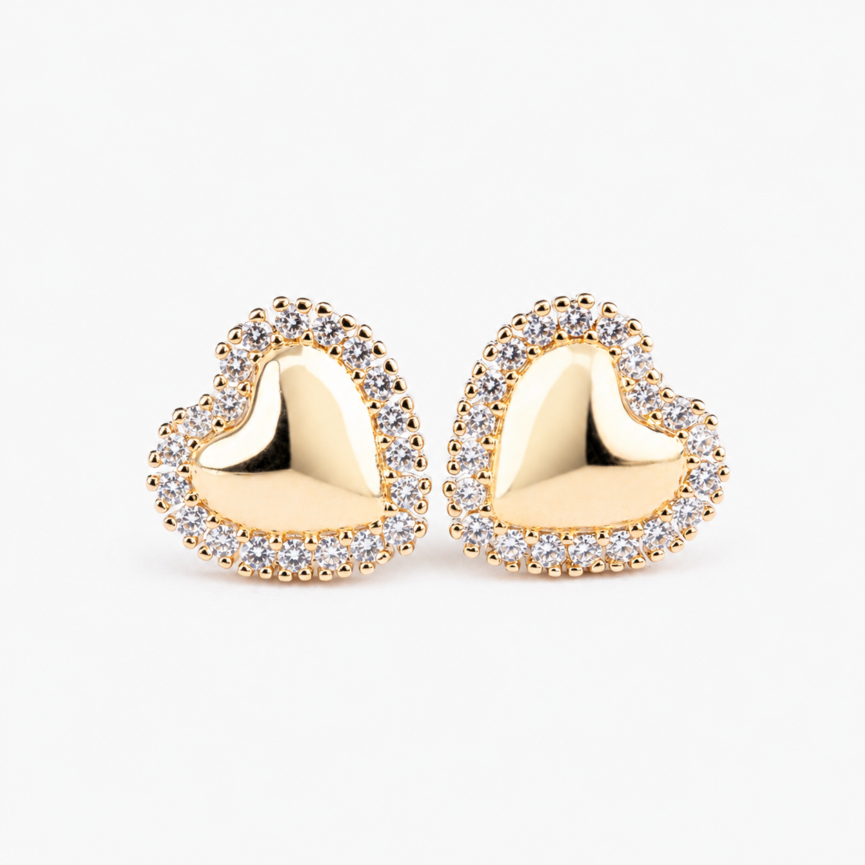 Boucles d’oreilles EMBLEM dorées en forme de cœur, serties de zircones blanches.